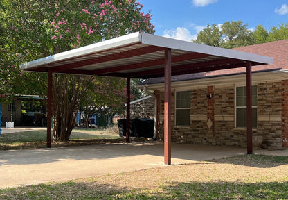Carport attached to a house with trees and blue sky in the background