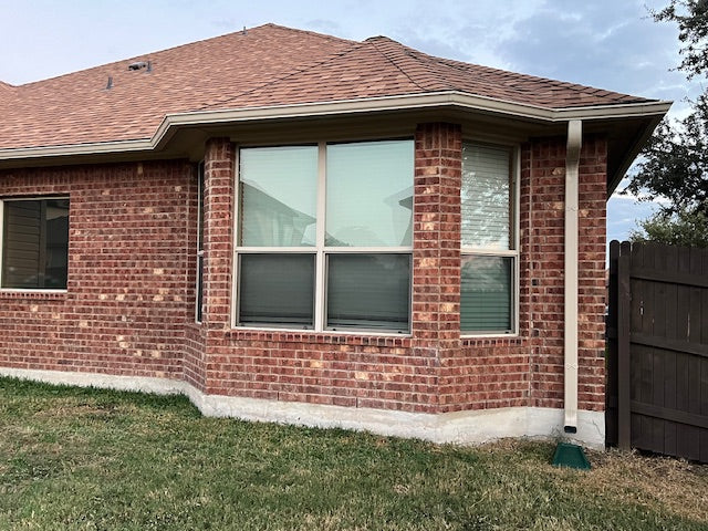 Gabled window full wrapped with new gutter installation and downspout.